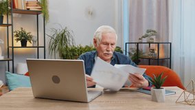 Stressed senior man at home room looking at unpaid bank debt bills, doing paperwork, planning budget calculate finances mortgage payments. Elderly mature grandfather throws paper bills sits at table - Powered by Shutterstock - Get 15% off with code: PIKWIZARD15