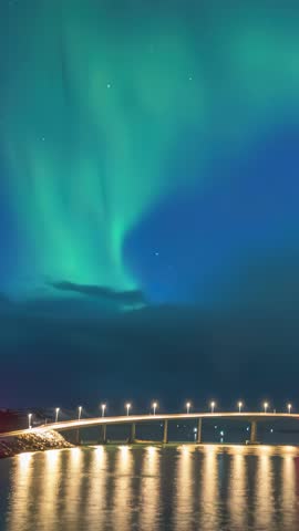 Tromso Norway time lapse of the aurora borealis northern lights winter landscape at Sommaroy bridge (Vertical)