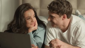 Couple woman man laptop bedroom home bed discussing conversation smiling laughing weekend together girl guy connection web leisure online technology talking device relationship beloved homeowner relax - Powered by Shutterstock - Get 15% off with code: PIKWIZARD15