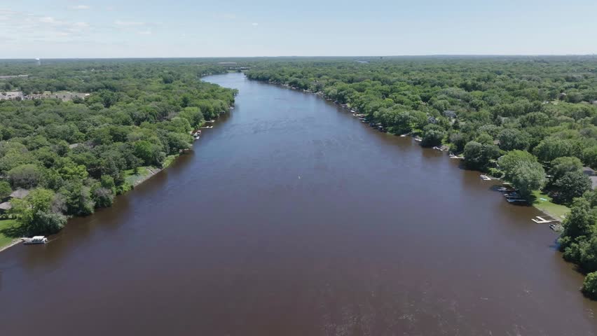 Wide angle shot capturing Mississippi river with dense forest on either ide in Minnesota, USA. Drone view.