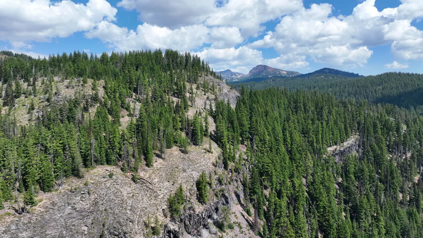Clouds drift over the scenic Sisters mountains not far from Bend, Oregon. Part of the cascade volcanic arc, these rugged mountains are stratovolcanoes and are popular for biking, hiking, and camping.