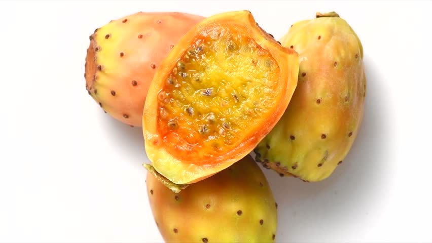 Prickly pear cactus, Opuntia edible fruit macro shot. Fresh tasty sweet exotic fruits isolated on white, rotating background. Opuntia ficus indica, top view, flat lay 