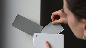 Woman compares paint swatches against a wall to find the perfect color match for a home interior project. Ideal for interior design, home improvement, and decorating projects - Powered by Shutterstock - Get 15% off with code: PIKWIZARD15