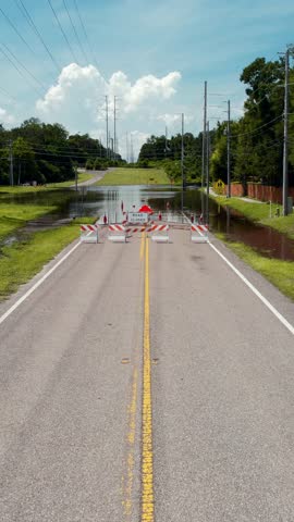 Flood or flooding. Florida flooding after hurricane or tropical storm. Flooded streets, road or highway. Hurricane season. Road closed. Destroyed after rain. City underwater. United States of America