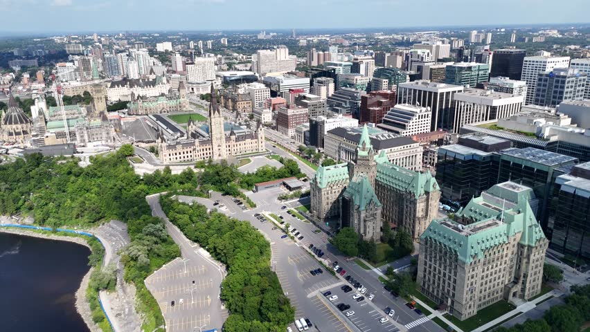 Drone view of Canadian Parliament, Parliament Hill, House of Commons, and East Block in downtown of Ottawa and river in a sunny day, Canada