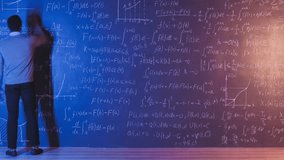 Zoom-in time lapse of African American researcher working in university classroom writing on chalkboard. Science and education concept. - Powered by Shutterstock - Get 15% off with code: PIKWIZARD15