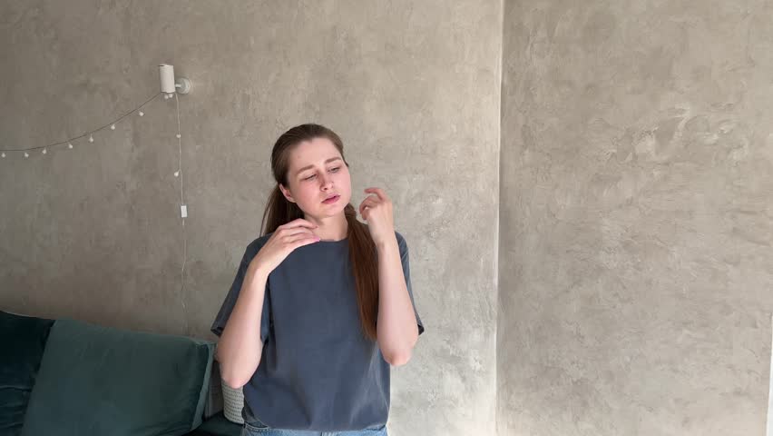 Woman with long hair practicing mindful hand movements for relaxation in a cozy living room with textured walls