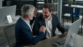 Excited joyful Caucasian men businessmen read good news on computer screen in office profitable business contract celebrating victory successful investment deal financial achievement celebrate success - Powered by Shutterstock - Get 15% off with code: PIKWIZARD15