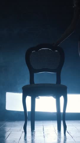 Silhouette of a sexy girl dancing an erotic sensual dance in blue smoke. Vertical video.