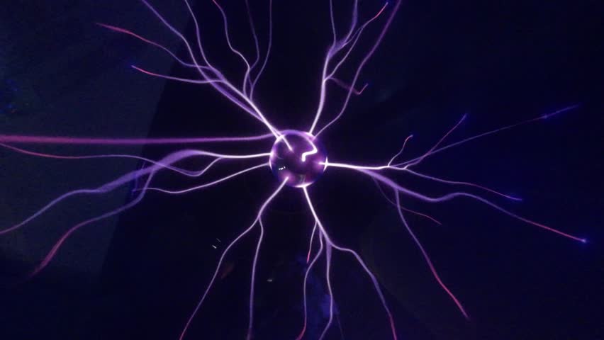 Plasma ball with purple blue rays, closeup. Tesla