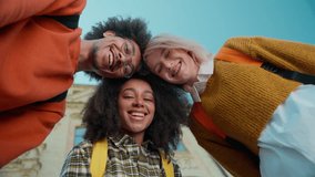 Bottom view three friends buddies students leaning heads African women girls females Caucasian man guy male looking at camera smiling city outdoors university college high school education friendship - Powered by Shutterstock - Get 15% off with code: PIKWIZARD15