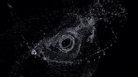 Circular splash of liquid in the center of the frame on a black background - Powered by Shutterstock - Get 15% off with code: PIKWIZARD15