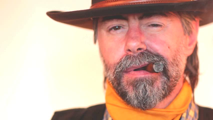Closeup portrait of cowboy smoking cigar. on white background 