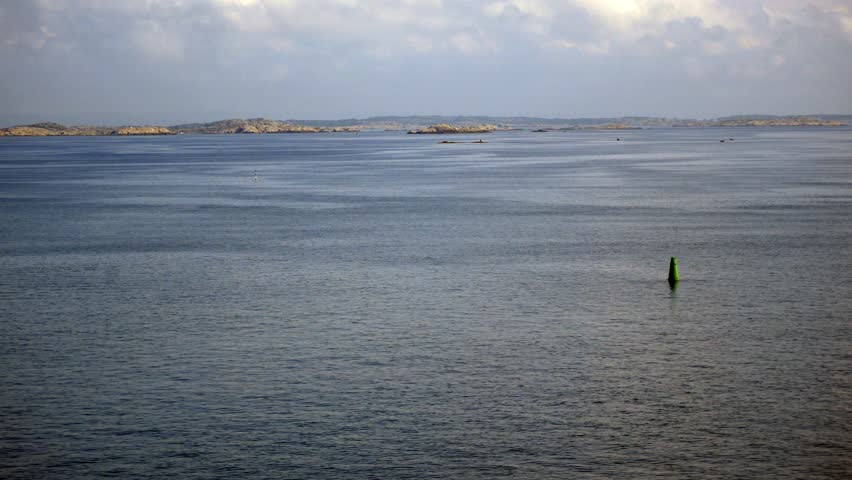 View from the ship to the port of Gothenburg harbor. Waterfront view of archipelago small stone islands in the sea.