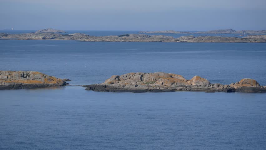 View from the ship to the port of Gothenburg harbor. Waterfront view of archipelago small stone islands in the sea.