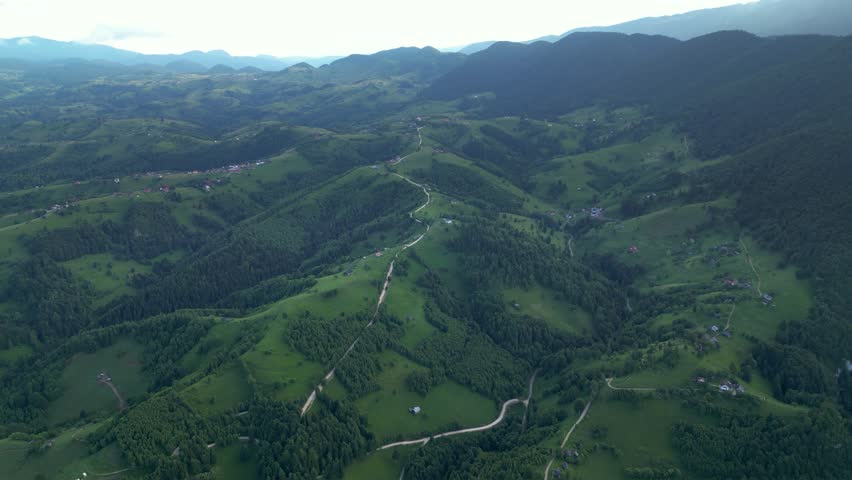 Aerial drone shot of Valea Prapastiilor as seen from the sky of Magura on a green sunny summer day. The romanian Carpathian mountains Piatra Craiului area seen from above. Top down footage of canyon.