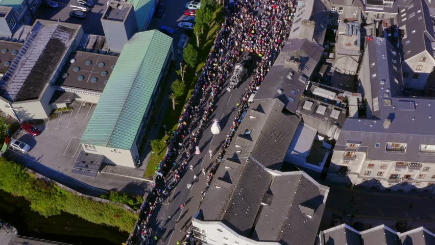 Galway international arts festival followed by a crowd of spectators. Aerial top down