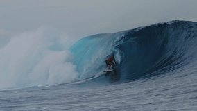 Surfer crouches down as they get barreled in heavy wave of Cloudbreak Fiji - Powered by Shutterstock - Get 15% off with code: PIKWIZARD15
