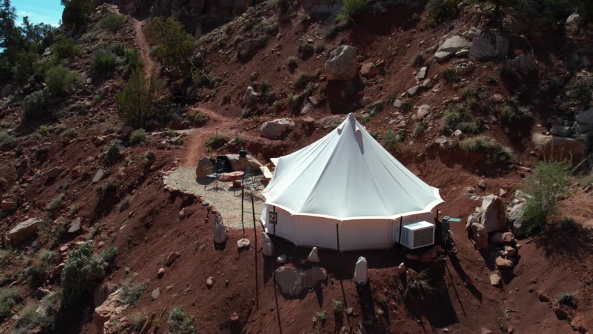 Drone Shot of Young Woman Going Out From Yurt Tent in Glamping Area and Landscape of Zion National Park, Utah USA