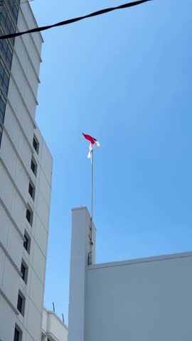 Indonesian flag flies on the top pole of the building