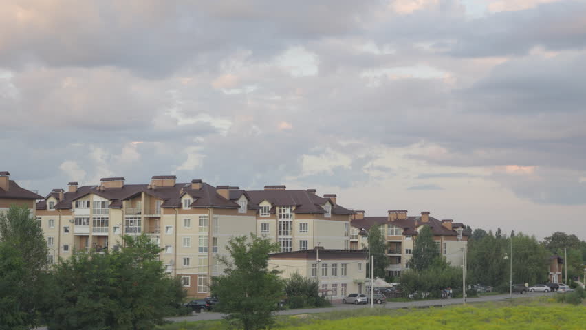 Time lapse. Clouds are moving over a middle-class suburban residential complex