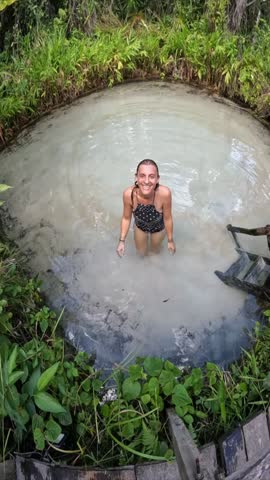 SSTKVertical. woman bathing in a spring in Jalapão, Tocantins