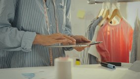 Industry. Trendy European woman in work uniform effectively conducts data analysis in studio. Cinematic shot young lady uses modern gadget follows modern fashion principles, sketch of clothing design - Powered by Shutterstock - Get 15% off with code: PIKWIZARD15