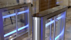 A confident businesswoman effortlessly passes through a modern turnstile using her personal access card in a sleek office lobby. Ideal for concepts of advanced security, workplace technology - Powered by Shutterstock - Get 15% off with code: PIKWIZARD15
