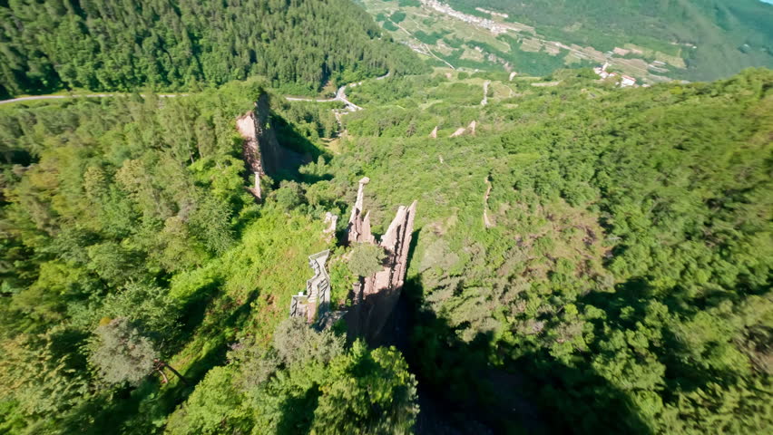 The piramidi di terra di segonzano in a lush green valley, aerial view