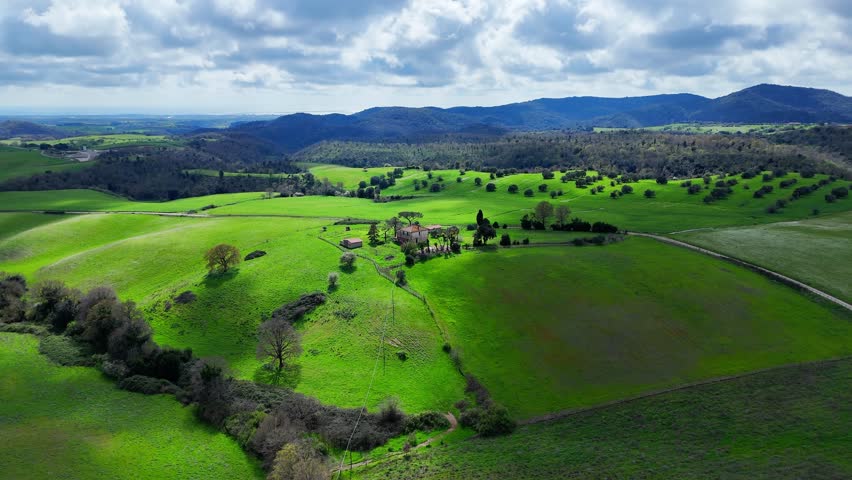 Lush Green Hills Embrace a Charming Farmhouse Under The Vast Open Sky in Spring