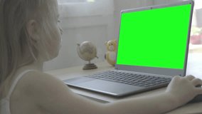 green screen display for video, smart 5-year-old child uses computer, primary school student front laptop, doing homework, Back to school concept, cyber safety, parental control technologies - Powered by Shutterstock - Get 15% off with code: PIKWIZARD15