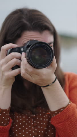 Photographer pointing lens at model with good angle