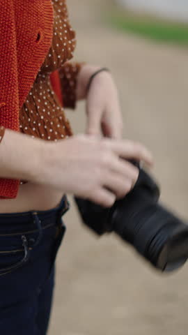 The photographer removes the camera cover and points to