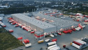 Aerial Twilight View of Massive Logistics Hub: Illuminated Warehouses, Automated Sorting Facilities, and Busy Truck Fleet | Modern Distribution Center Operations | Drone Establishing Shot - Powered by Shutterstock - Get 15% off with code: PIKWIZARD15
