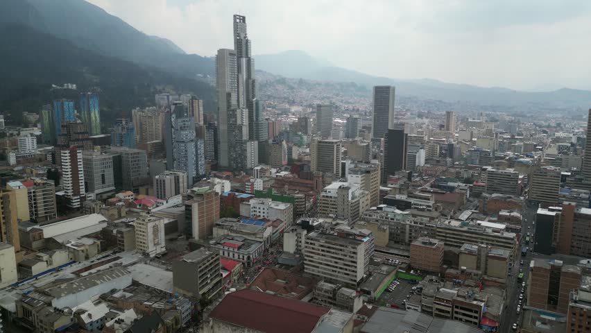 Flyover of hazy mountain city skyline of Bogota Colombia skyscrapers
