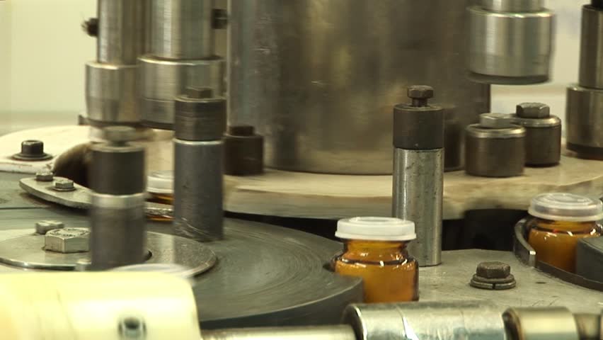 Automated production of medicines. Packaging of tablets in a glass container