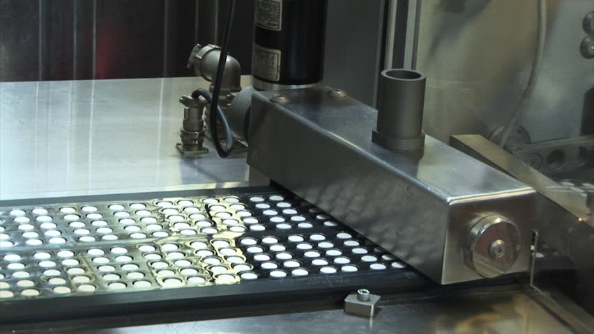 Automated production of medicines. Creating a pill. Tablets on the conveyor