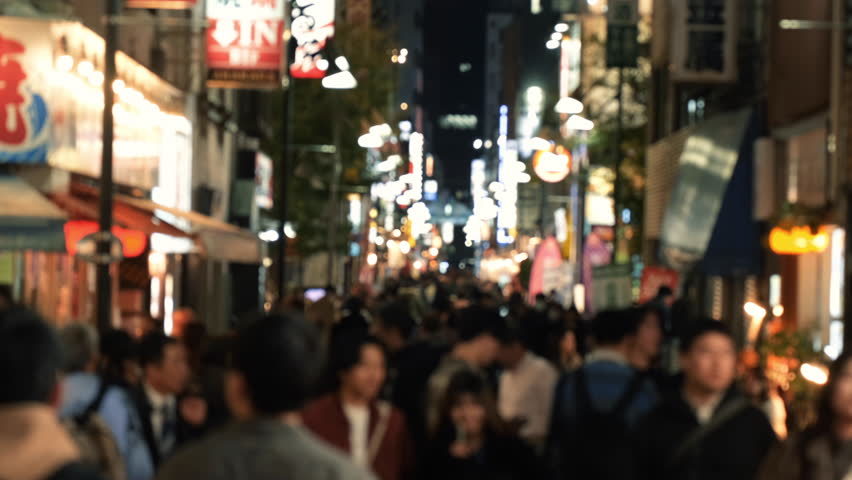 Pedestrians walk at Shibuya famous crossing street in Tokyo, Japan.
