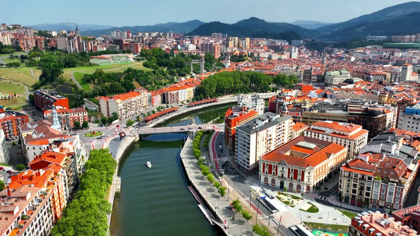 aerial view of Bilbao cityscape with a bridge and Nervion river in Bilbao, Basque Country, Spain. Idyllic town in Northern Spain, drone view of downtown Bilbao