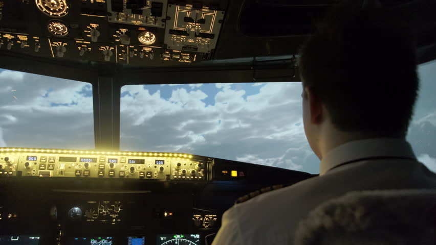 Professional pilot guides aircraft among clouds. Modern cockpit of airplane with illuminated panel provides crucial information - Powered by Shutterstock - Get 15% off with code: PIKWIZARD15
