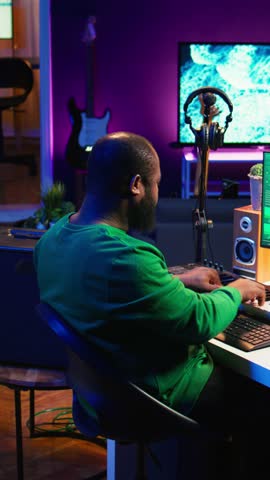 Vertical Video Artist playing electronic piano keyboard notes and recording audio files to use mix and master techniques, editing recordings to edit sound effects. Musician operating on synthesizer