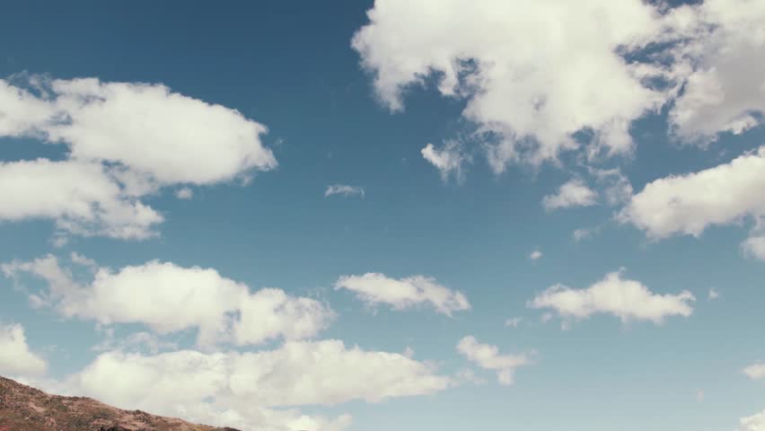 Aerial drone shot panning down from clouds to mountains in Salt Lake City with fall-colored leaves at 60fps.
