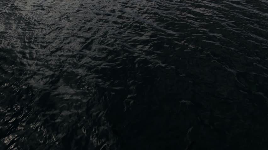 Low-flying drone over lake rises to reveal the mountain ranges in Salt Lake City Utah at 60fps.