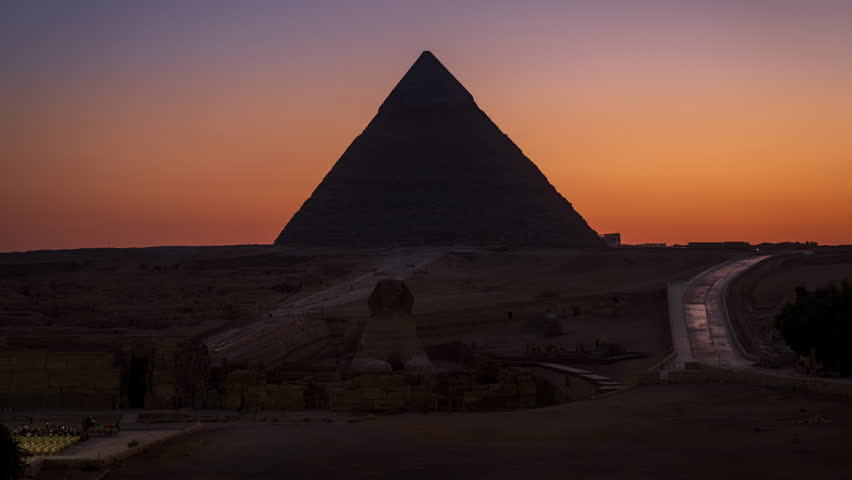 Day to night timelapse and the light show of the Khafre pyramid in Giza near Cairo with the Great Sphinx in front