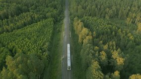 Passenger train traveling on a track through a forest, highlighting the concept of ecological transport, city connections, and an alternative to other means of transport, sustainable development. - Powered by Shutterstock - Get 15% off with code: PIKWIZARD15