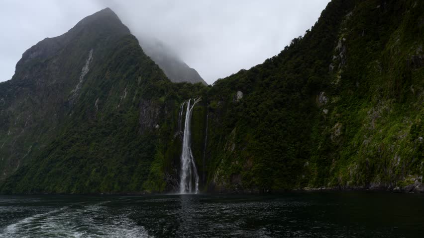 View of water falling down from the Stirling Waterfall in Milford on a cloudy day.