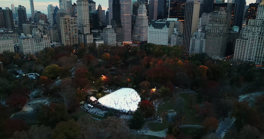 Cinematic aerial view of the autumn Central Park with various modern buildings and epic skyscrapers.