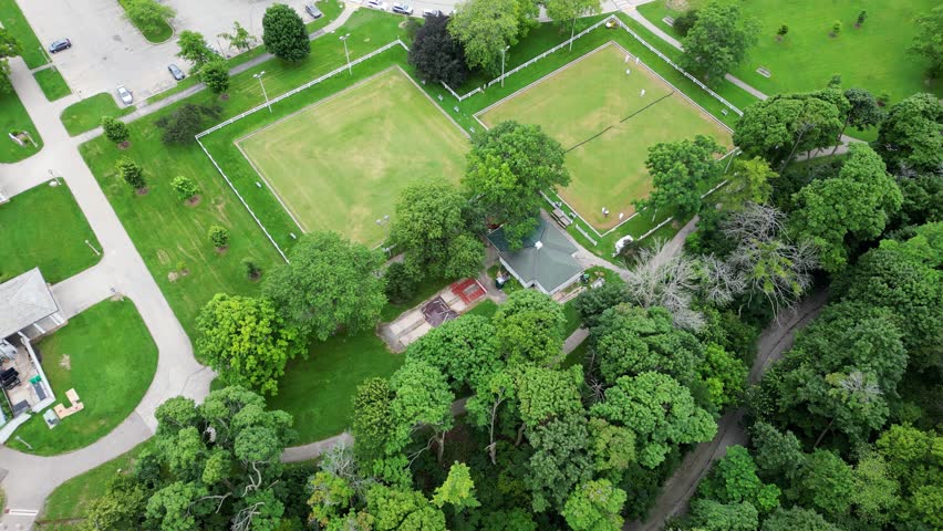 Outdoor Sports Complex (Golf, Soccer, And Rugby Field) In Lake Park, Milwaukee, Wisconsin; 4K Aerial Flyover, Drone Tilt Up Towards Downtown Skyline.