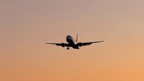 Large airliner with passengers on blue sky is landing on landing strip at airport of bright orange sunset on sunny summer day. Go Everywhere. Airplane flies in sky at sunset day lens flares. Travel - Powered by Shutterstock - Get 15% off with code: PIKWIZARD15