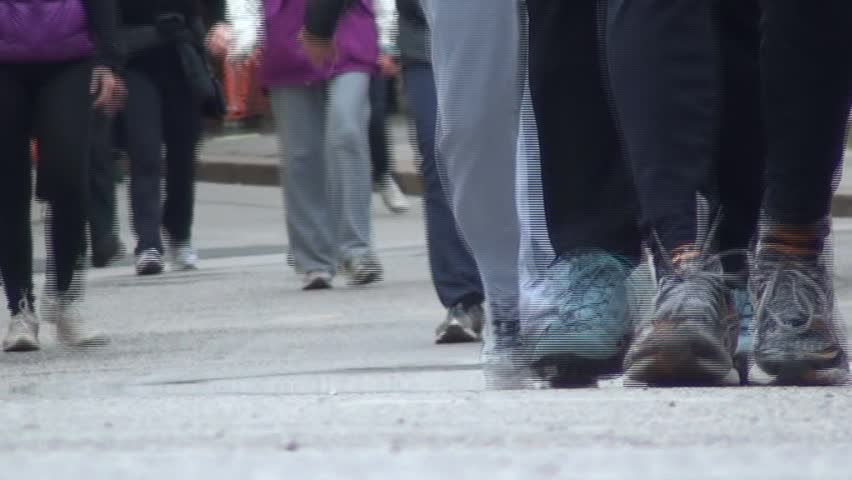 runners with sneakers around the city during the footrace